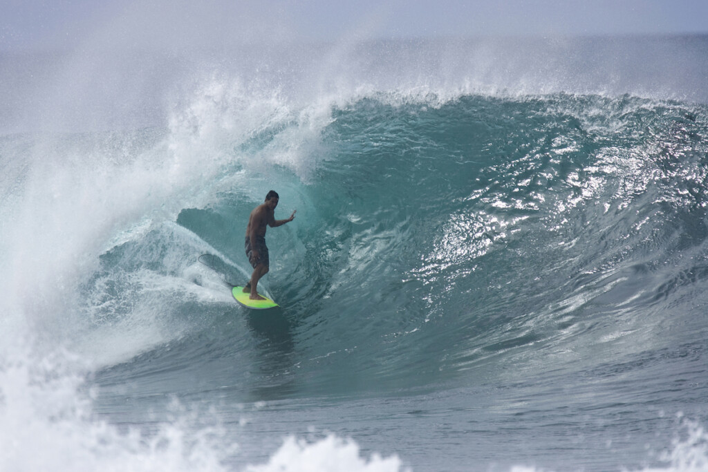 A Young Man Surfing At Pipeline On The North Shore Of Oahu, Hawaii.