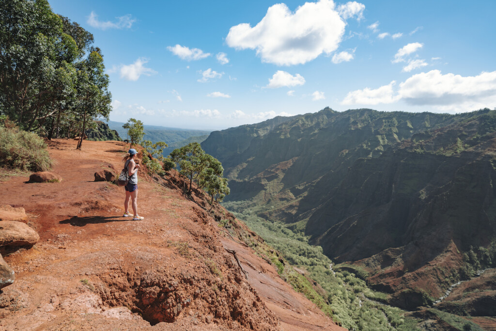 Woman On Waipo'o Falls Via Pu'u Hinahhina And Canyon Trail Koke'e State Park Kauai Hawaii Usa