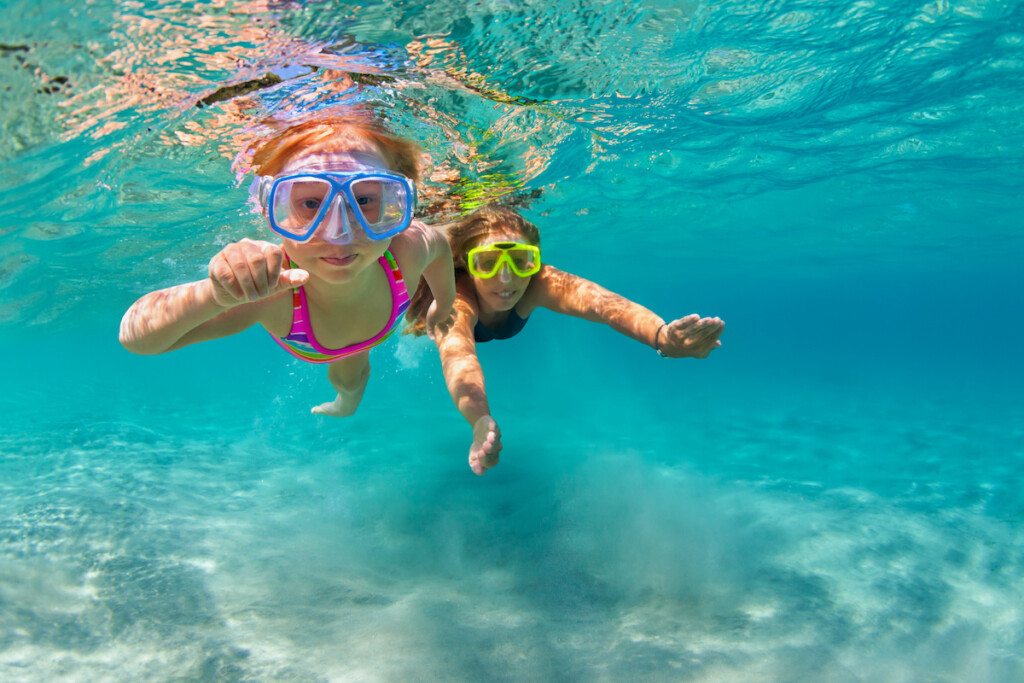 Mother With Child Swim Underwater With Fun In Sea