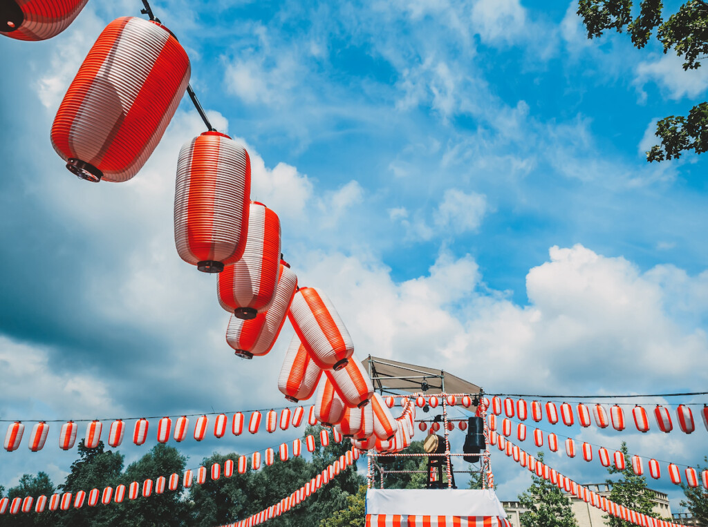 The Stage Of The Yagura With A Big Japanese Taiko Drum Odaiko. Paper Red White Lanterns Chochin Scenery For The Holiday Obon When People Dance Of Bon Odori