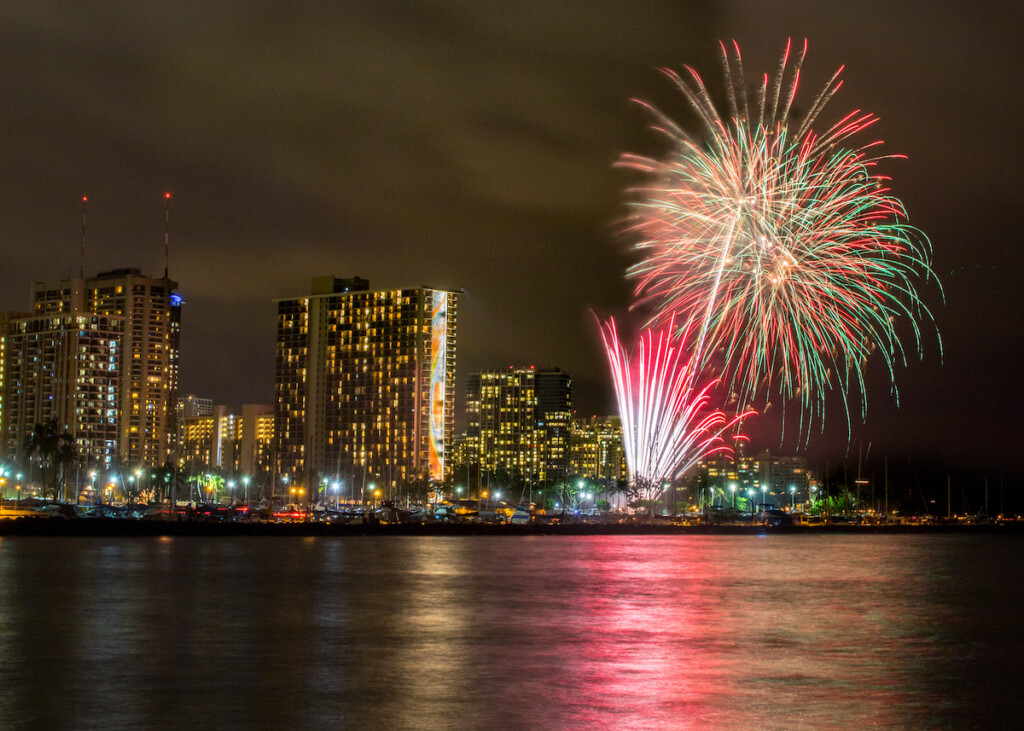 Fireworks At Harbor With Reflection In Water At Magic Island, Honolulu
