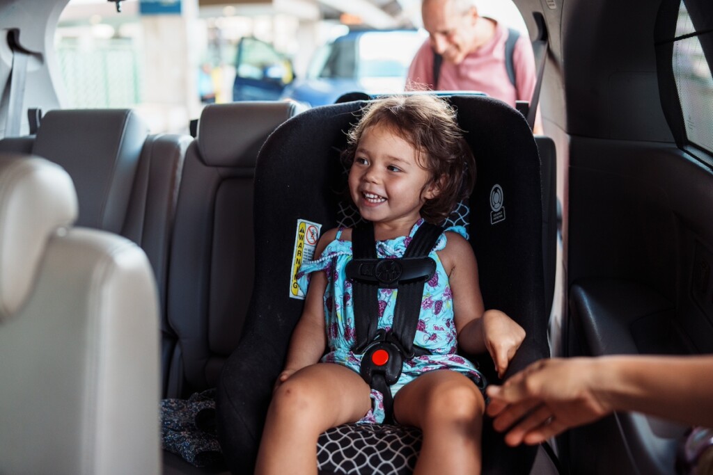 Little Girl Giggling With Excitement While Greeting Family At The Airport
