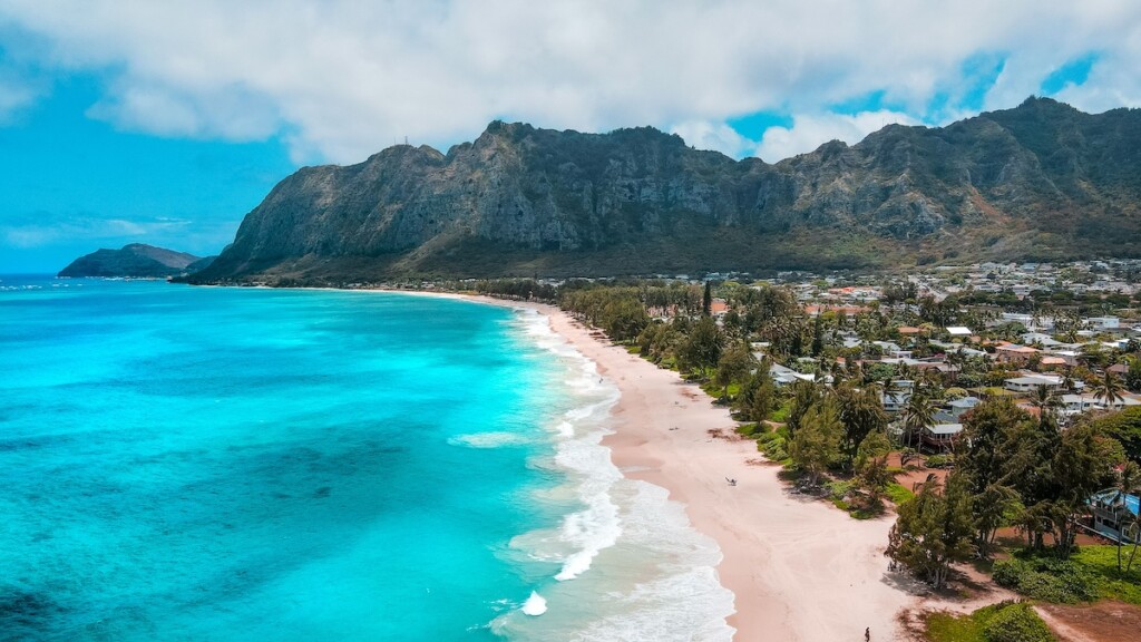 Scenic Waimanalo Beach With A Turquoise Seascape With Foamy Waves Washing The Shore In Hawaii