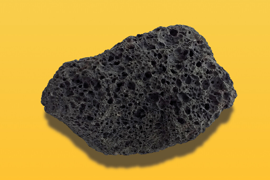 Porous Black Volcanic Rock Isolated On White Background. Lava Stone, Pumice Stone, Or Volcanic Pumice With Distinctive Pores, Isolated On White. Close Up.